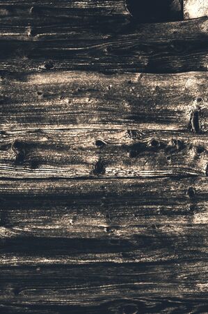Old faded brown knotted horizontal wooden boards from time to time close-upの写真素材