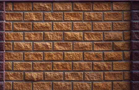 Wall of rough textured natural sandstone, yellow brickworkの写真素材