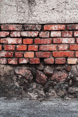 brickwork of old red brick with shabby plaster backgroundの写真素材