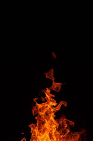 Bright colorful raging flames of burning fire. Lighted bonfire against black background closeupの写真素材
