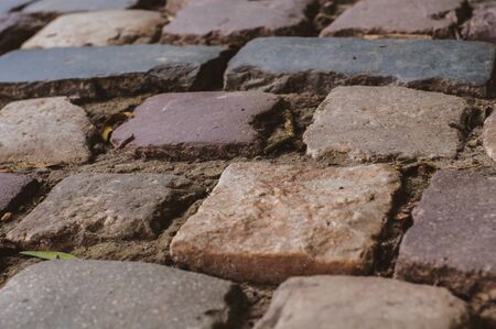 Pavement of smooth textured old natural stone, close-upの写真素材