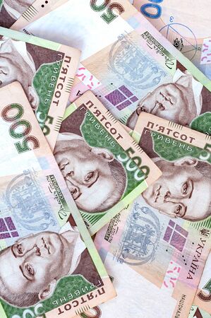 National currency five hundred hryvnia. Vertical background. Background from banknotes Ukrainian hryvnia. Randomly scattered denominations five hundred hryvnia. National currency. Ukrainian money.の写真素材