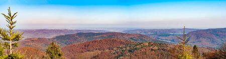 Autumn landscape woods on slopes. Mountain Village. Carpathians, Ukraine, Europe. View from high mountain on picturesque landscape. Bright fresh blue skyの写真素材