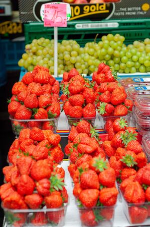 Sale juicy, fresh strawberries, blackberries in market square, Prague, Czech Republic. Nutritious healthy berry diet food. Berries close up.の写真素材