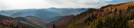 Dramatic sky. Ukraine, Europe. View from high mountain on picturesque landscape autumn Carpathian. Colorful nature, green coniferous forest. Majestic sunset in mountains landscape. World of beauty.の写真素材