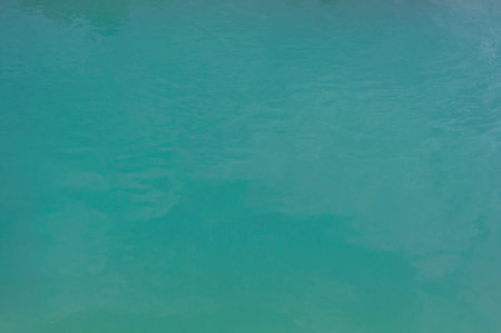 Background close-up, turquoise green water surface lake, outdoors, horizontal photo.