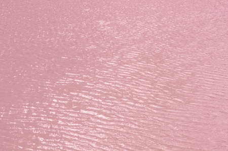 Bright, colorful background close-up, pale pink water surface lake, outdoors, horizontal photoの写真素材