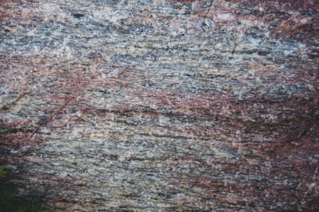 Background from with granite rocks, old cracked weathered stones, atmospheric influence, outdoors, horizontal photo close-up.の写真素材