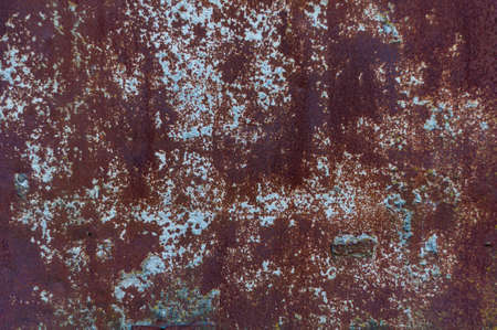 Bright colorful background from rusty metal with old shabby cracked paint, atmospheric impact, outdoors, horizontal photo. Close-up.の写真素材