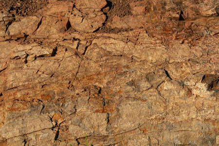 Background from with granite rocks, old cracked weathered stones, atmospheric influence, outdoors, horizontal photo close-up.の写真素材
