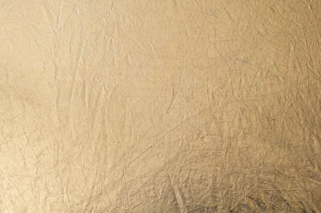 Gold texture, fabric reflector, simple stretched gold background, horizontal photo.の写真素材