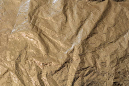 Texture golden fabric reflector, simple, crumpled gold background, horizontal photo.の写真素材