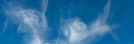 Panorama blue sky with cobweb clouds, bright, colorful background close-up, outdoors, atmosphere, horizontal photo.の写真素材