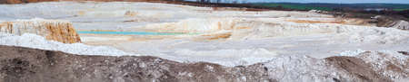 Vivid panorama quarry, recovery white clay, turquoise lake, natural landscape in outdoors, human intervention. Horizontal photo.の写真素材