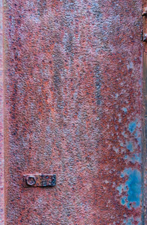Rusty metal surface, not painted, oxidized rough texture, brown rust with peeling blue paint, outdoors, vertical close-up photo, blank template for banner design.の写真素材