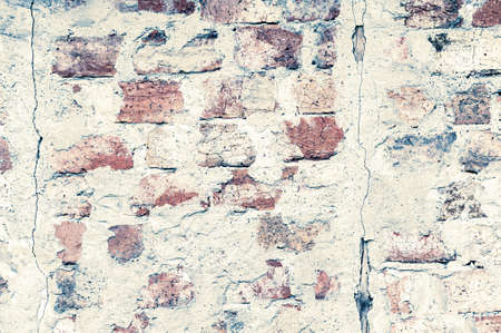 Grunge background from old brick wall, shabby white plaster, texture damaged concrete surface, horizontal photo close-upの写真素材