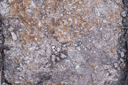 Textured background from old wall, damaged concrete slab material, crumbled surface with yellowed moss, uneven texture.の写真素材