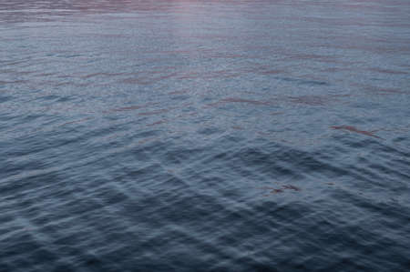 Colorful sunset, bright reflection warm sun rays illuminates dark cloudy sky. Outdoors. Horizontal photographyの写真素材