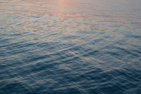 Bright colorful reflection warm sunlight, sunset illuminates dark cloudy sky. Outdoors. Horizontal photographyの写真素材