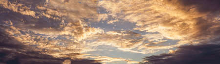 Bright colorful reflection warm sunlight, sunset illuminates dark cloudy sky. Outdoors. Horizontal photographyの写真素材