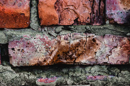 Grungy texture. Handmade red brick close-up, Background old surface, vintage cracked wall.の写真素材