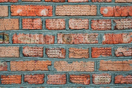 Background old surface, vintage cracked wall, red handmade brick close-up, grungy texture.の写真素材