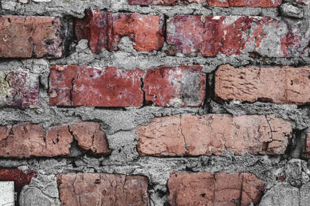 Background old surface, vintage cracked wall, red handmade brick close-up, grungy texture.の写真素材