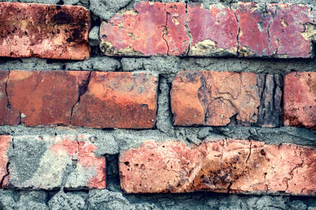 Background old surface, vintage cracked wall, red handmade brick close-up, grungy texture.の写真素材