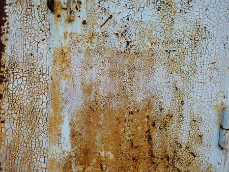 Old faded blue paint on an iron surface. Rough texture with cracked peeling paint. Close-up background. Horizontal photoの写真素材