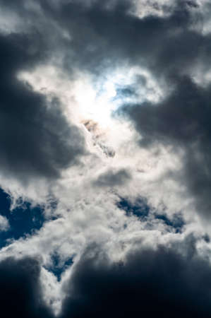 Cloudy skies with white-gray rain clouds obscured the sky and bright sun.の写真素材