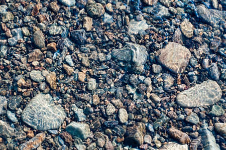Vertical granite rock face overgrown with vegetation, outdoorsの写真素材