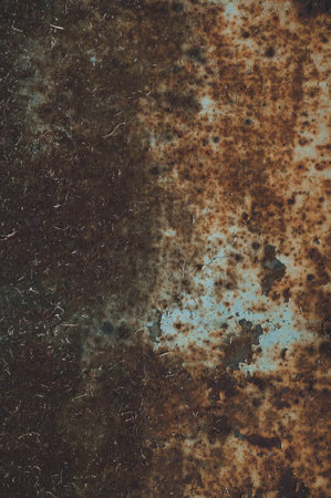 Rusty sheet of metal with peeling faded paint, covered with dust and dirt, grungy texture surface, close-up vintage backgroundの写真素材