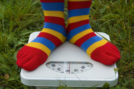 The woman in streaky half-hose is weighed on a background of the nature.の写真素材