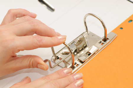 loose-leaf binder in hand isolated on a white backgroundの写真素材