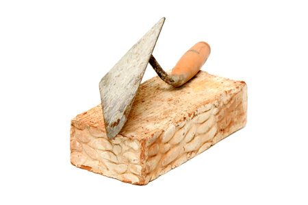 Brick and trowel isolated on a white background.の写真素材
