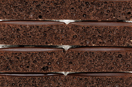 Black porous chocolate isolated on a white background                                    の写真素材