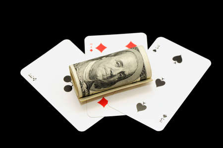 dollars and playing cards isolated on a black backgroundの写真素材