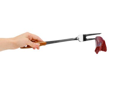 raw meat on a fork isolated on whiteの写真素材