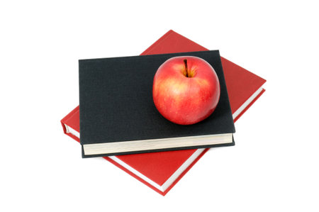 red apple on a book isolated on whiteの写真素材