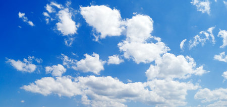 white fluffy clouds in the blue sky                                    