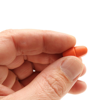 pill in a hand isolated on white background                                    