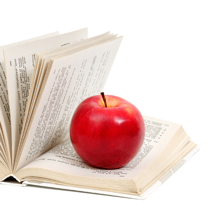 red apple on a book isolated on white                                    の写真素材