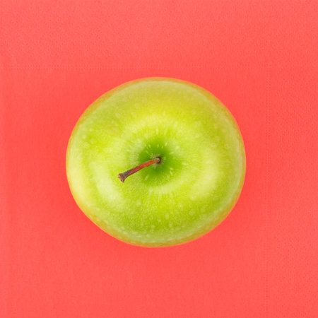 Green apple on a red napkin                                     