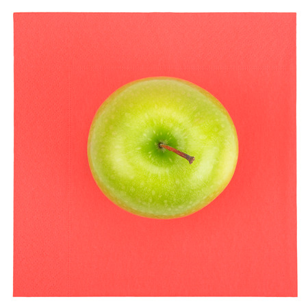 Green apple and red napkin isolated on white                                    の写真素材