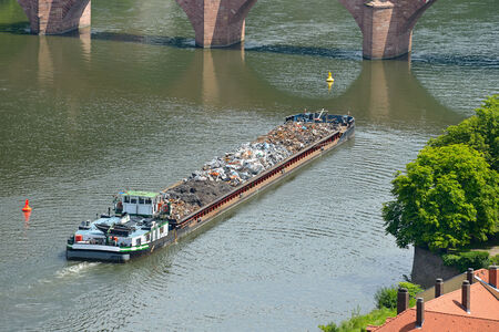 Barge transports waste on the riverの写真素材