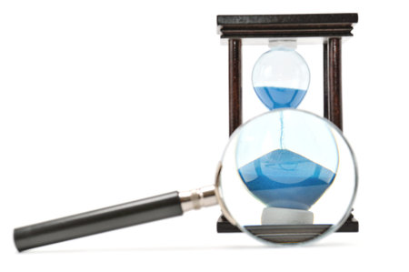 hourglass and magnifying glass isolated on a white
