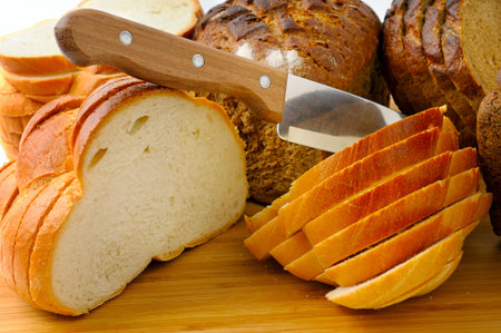 cut bread and knife isolated on white