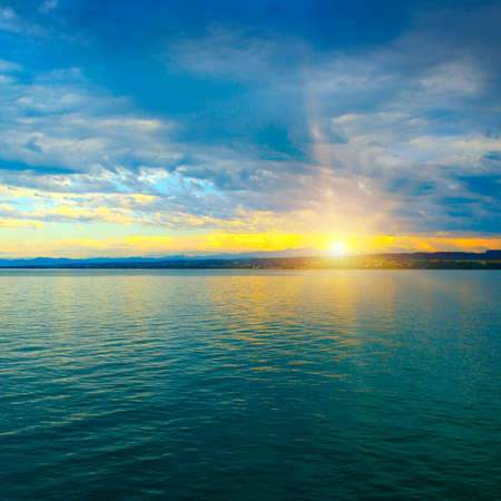 Dawn above sea and blue skyの写真素材