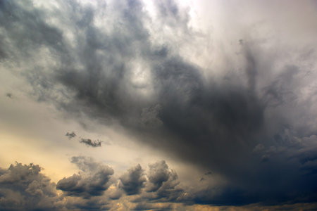 Heavy storm clouds cover the sun. Dramatic sky.