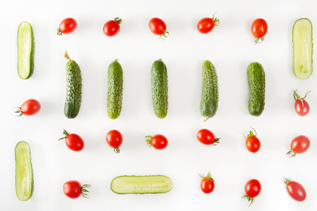 Fresh vegetables - cucumbers and tomatoes isolated on white background. Pattern flat lay.の写真素材